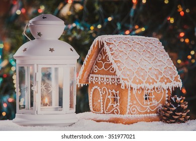 The Gingerbread House Over Defocused Lights Of Chrismtas Tree