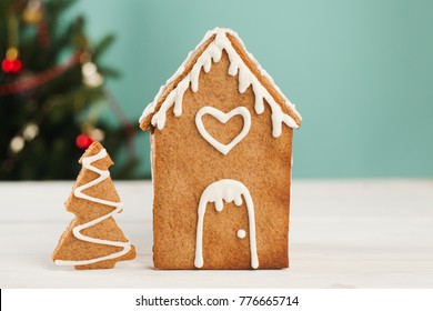 Gingerbread House And Gingerbread Tree On A Light Blue Background, Copy Space. Homemade Sweetness For Xmas, New Year 2022, Banner For Site, Flyer, Invitation