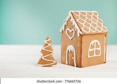 Gingerbread House And Gingerbread Tree On A Light Blue Background, Copy Space. Homemade Sweetness For Xmas, New Year 2022, Banner For Site, Flyer, Invitation