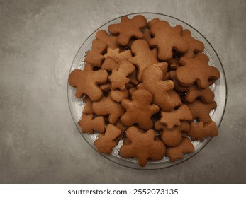 Gingerbread men and comets shaped cookies arranged on a glass plate, capturing the essence of christmas baking and holiday cheer, copy space - Powered by Shutterstock