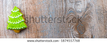 Gingerbread in the shape of a Christmas tree on a wooden board. Banner or cover for the site. Copyspace.
