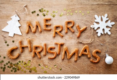 Gingerbread Words Merry Christmas On Old Wooden Table