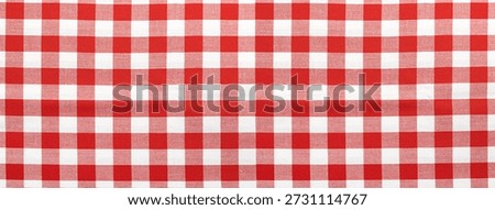 Gingham checkered tablecloth fabric with a pattern of red and white squares