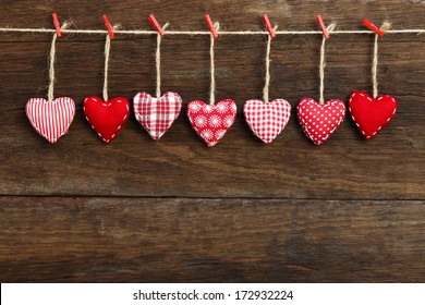 Gingham Love Valentine's hearts natural cord and red clips hanging on rustic driftwood texture background, copy space - Shutterstock ID 172932224