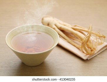 Ginseng Tea On Wood Background, The Concept Of Healthy Drink.