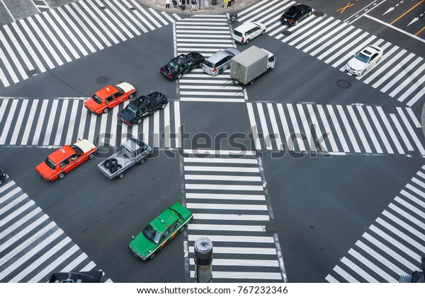 Ginza, Tokyo / JAPAN - May 14, 2016: Cars and\
pedestrian crossing on\
road