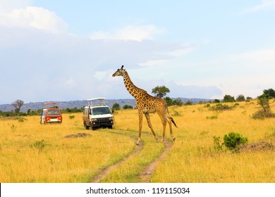 Giraffe Crossing The Road In Masai Mara National Reserve, Kenya