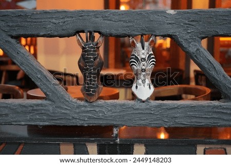 Giraffe and zebra mask carved in African style