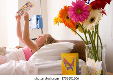 Girl 8 To 10 In Hospital Bed Reading Card, Side View