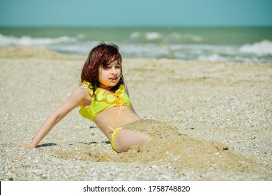 Girl 9 years old at sea. The portrait of the young girl about 9-12 years old. Teenager summer vacation sand. Sunny day and the sea. Childhood travel vacation. Little girl rejoices in pestilence.