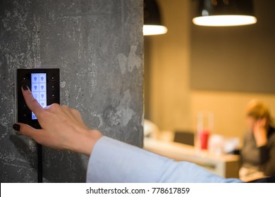 girl adjusts the lighting in the room with a touch switch