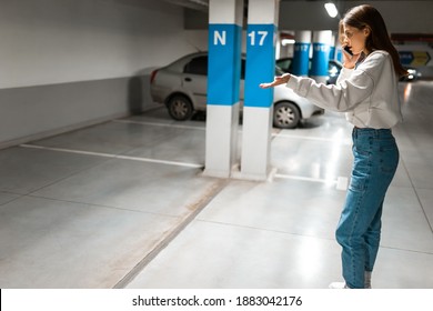 Girl after shopping discovered the loss of her automobile. Angry woman talking about missing car on phone. Vehicle theft concept