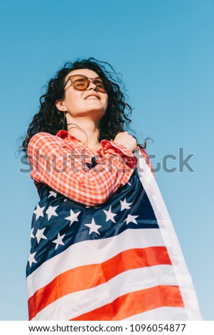 Girl with an American flag. Independence Day concept