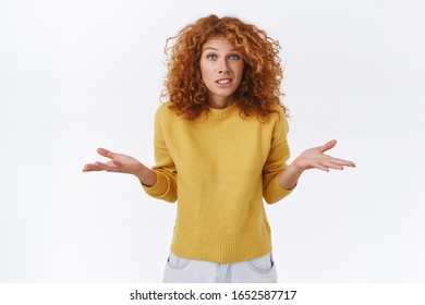 Girl Apologizing, Shrugging As Dont Know, Cant Help. Cute Silly And Awkward Redhead Woman In Yellow Sweater, Spread Arms Sideways, Smiling Clumsy And Embarrassed, Admit Her Fault, White Background