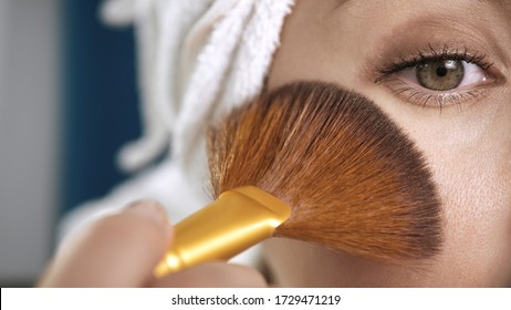 Girl Applying On Face Shine For Skin. Macro Shot Of Attractive Woman With Towel Puts Highlighter Or Bronzer On Skin. Make-up Artist, Beauty, Body Care, Preparation Of Date Or Celebration Concept