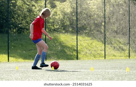 Girl Arranges Flip Cups At Football Practice - Powered by Shutterstock