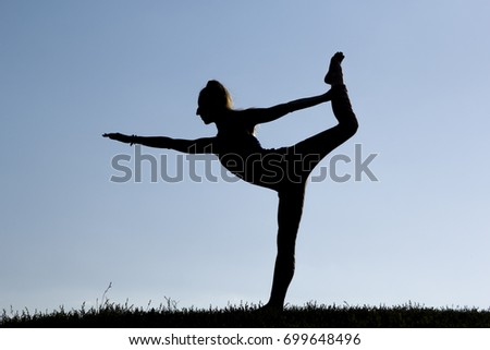 Similar – Young woman doing yoga in nature