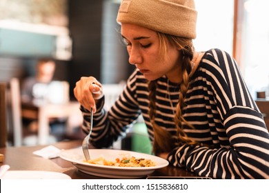 Girl in the Asian fst food cafe getting lunch. Woman eating Asian food.