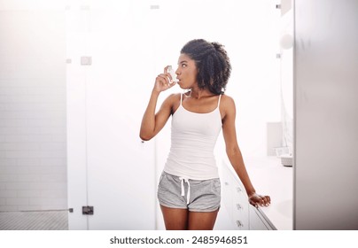 Girl, asthma inhaler and breathe with pharmaceutical product, medication or healthcare. Black woman, pump and spray for oxygen, home and emergency care for lungs in bathroom with morning routine - Powered by Shutterstock