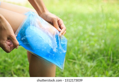 Girl Athlete Using Cold Jell Pack For Healing Pain At Knee And Ankle From Playing Hard Sport. People Daily Life Activity Concept 