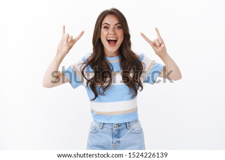 Girl attend concert favorite band go wild adore awesome music festival. Pleased excited woman having fun dancing and cheering, smile happy show rock-n-roll sign enthusitastic, heavy metal gesture