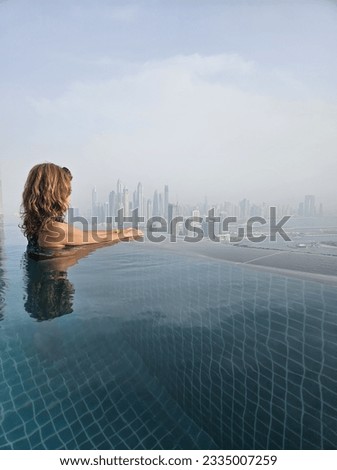 Girl in Aura Skypool looking at the view