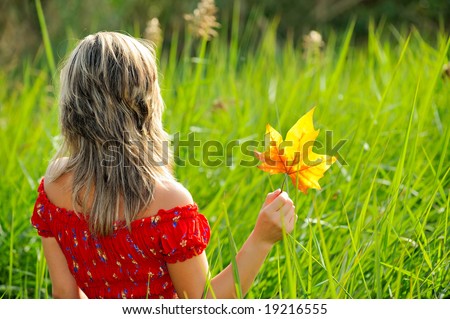 girl with autumn leaf outdoor