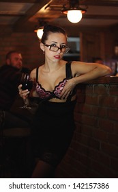 the girl at the bar with a cocktail