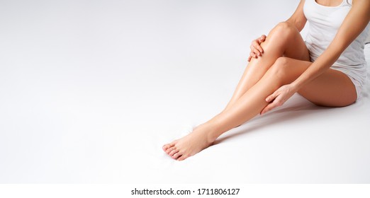 Girl With Bare Legs Sitting On Bed At Home