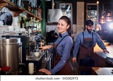 Girl Barista Bartender Waiter In Uniform Making Coffee At The Bar