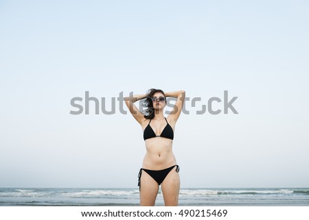 Similar – Brunette surfer woman in bikini standing with surfboard