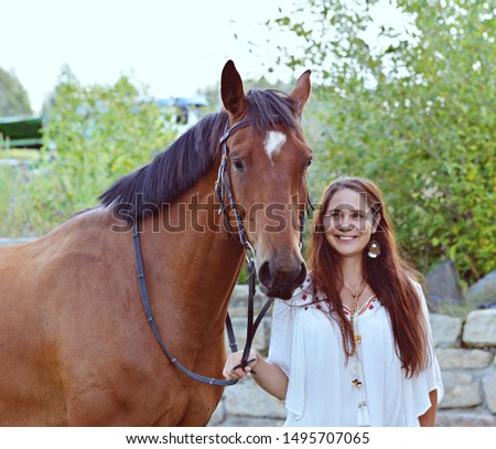 Girl with beautiful horse in hat