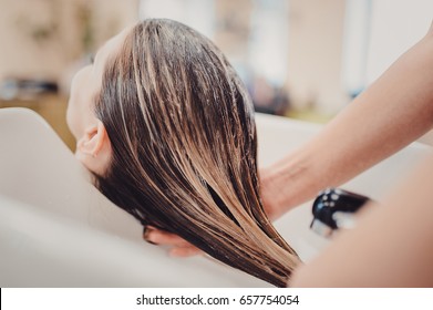 girl in a beauty salon. wash your hair, hair care, health. Process of washing your hair in a hairdresser - Powered by Shutterstock