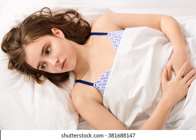 Girl Became A Woman Concept - Young Girl Lying With Period Pain