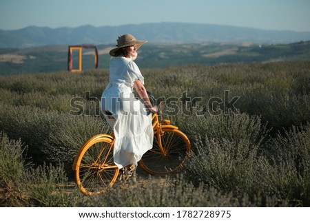 girl with a bicycle in lavender field