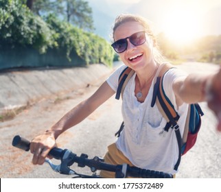 Girl With A Bicycle Makes Selfie On A Smartphone. Summer Vacation And Travel By Bicycle, Sports And Outdoor Activities.