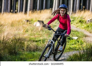 Girl biking on forest trails  - Powered by Shutterstock