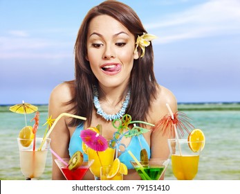 Girl in bikini on beach drinking cocktail. - Powered by Shutterstock