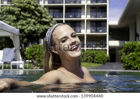 girl in bikini in a resort swimming pool