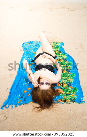 Girl in bikini sunbathing on the beach