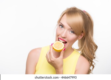 Girl Biting A Lemon