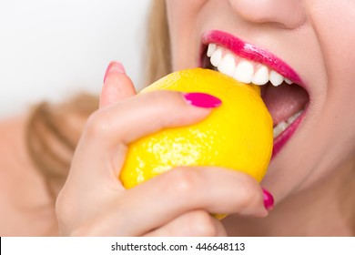 Girl Biting A Lemon