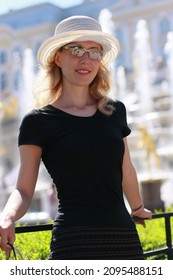 Girl in a black blouse and sunglasses