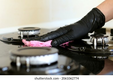 Girl In Black Disposable Gloves Washes The Hob, Glass Surface