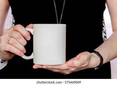 Girl In Black Dress Is Holding White Cup, Mug In Hands. Mockup For Designs.