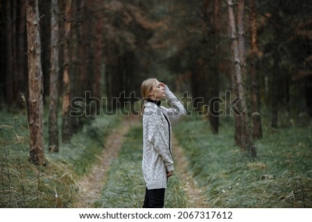 Image, Stock Photo Young woman with hat taking a walk in the deep forest at sunset.