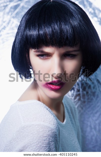 Girl with black hair style and broken makeup.\
Smooth pink lips.