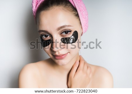 Girl with black patches mask under the eyes
