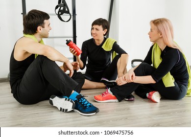 The girl in a black tight suit offers a man a bottle of water - Powered by Shutterstock