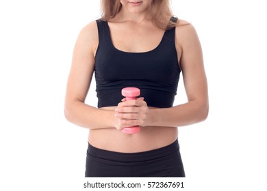 Girl In Black Top Stands Up Straight And Holding Small Dumbells